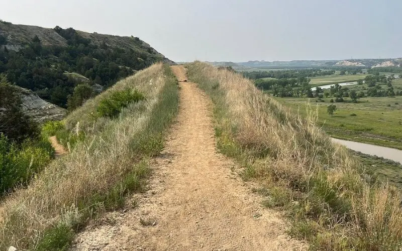 Dirt pathway overlooking valleys along the Maah Daah Hey Trail.
