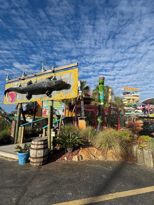 Entrance with alligator sign at Gator Beach at Fudpucker's.