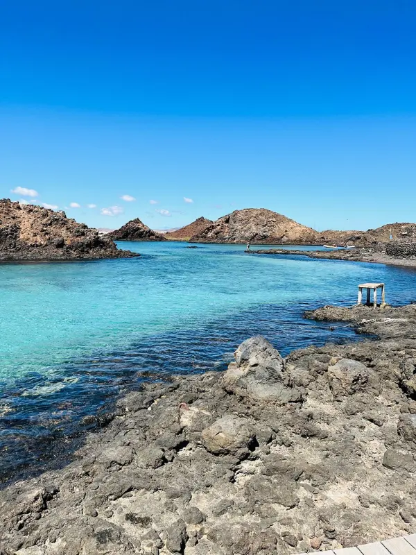 Clear blue water and rocky shoreline at the Island of Lobos.