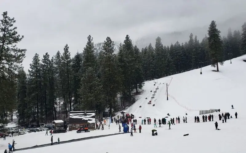 Snowy slope with skiers and visitors at Leavenworth Ski Hill.