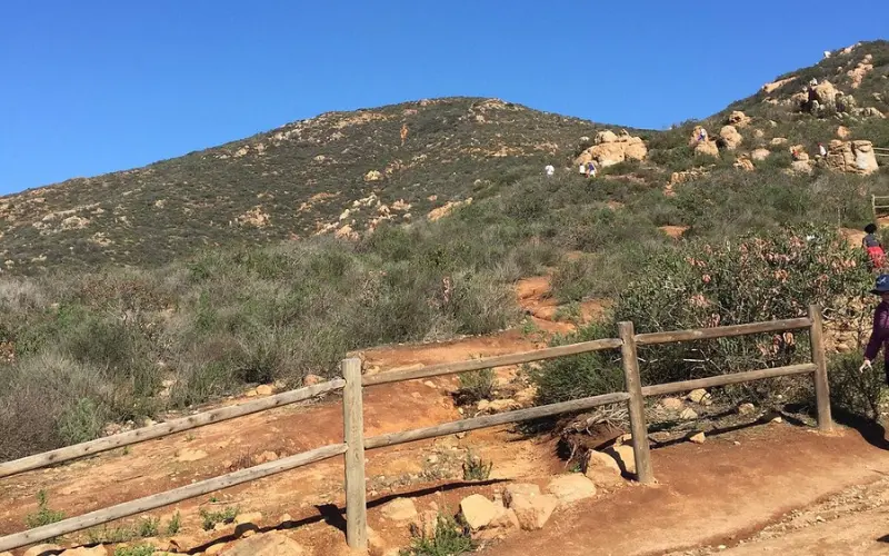 Hikers climb the rocky trail up Cowles Mountain.