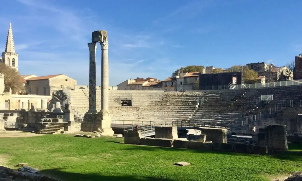 Ancient stone columns and seating remain at the Roman amphitheatre in Arles.