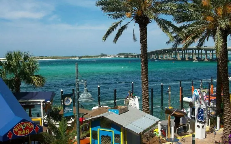 Palm trees and turquoise water along the Destin Harbor Boardwalk.