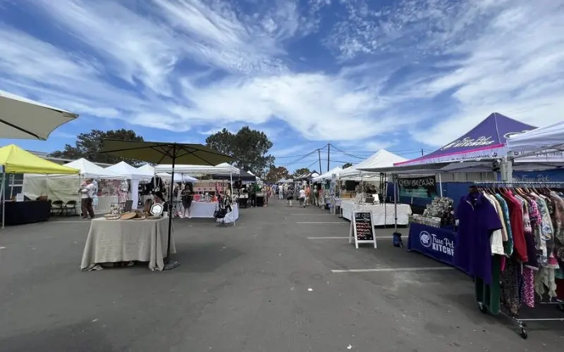 Vendor tents and shoppers at the La Jolla Open Aire Market.