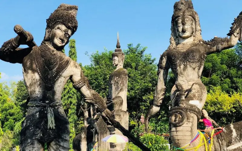 Large stone statues stand in the Buddha Park of Nong Khai.