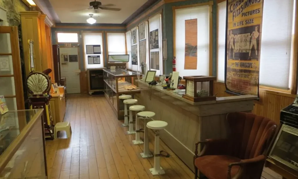 Interior of the Ouray County Historical Museum with wooden floors and vintage displays.