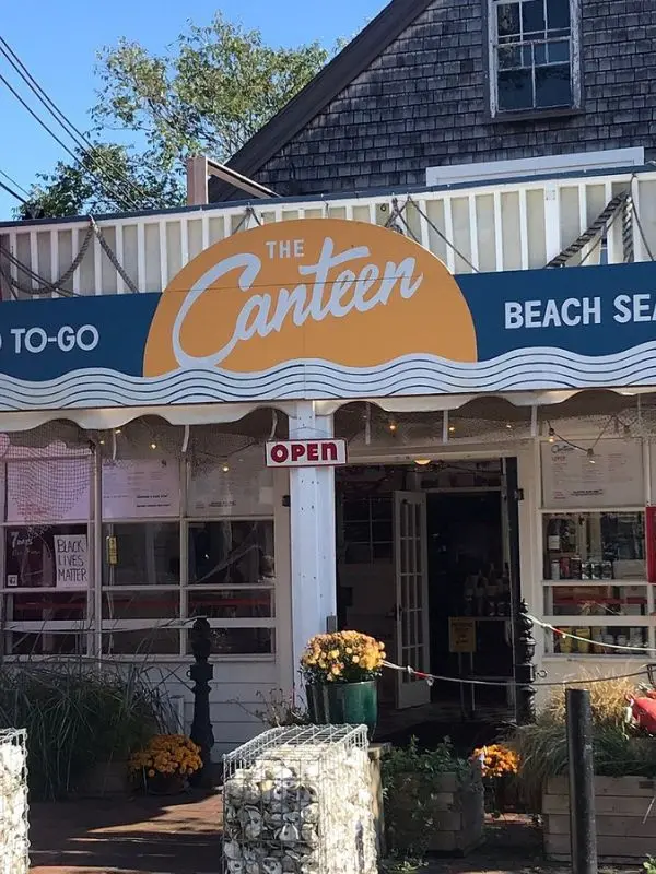 Front entrance of The Canteen with a bright sign and open doorway.