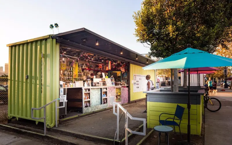 Bright shipping-container café and umbrellas make up Quartyard.
