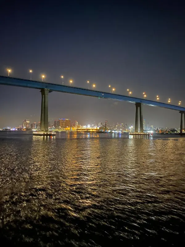City lights reflect on the water during a San Diego Bay Dinner Cruise.