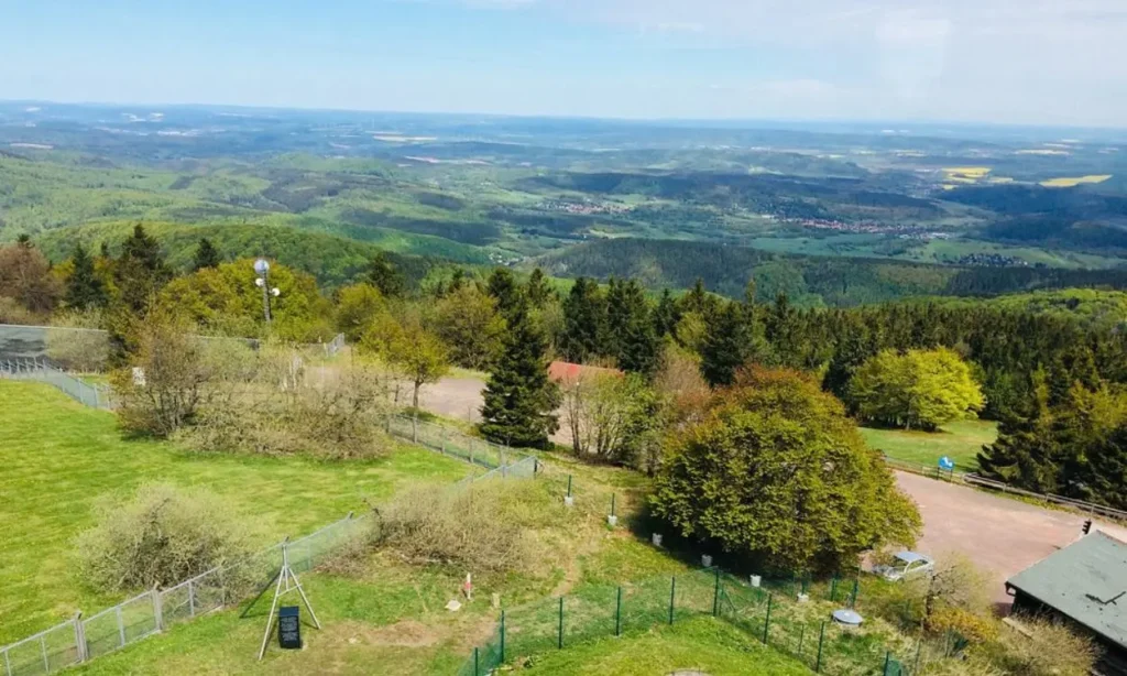 Panoramic view over green hills and valleys from a high point on the Rennsteig.