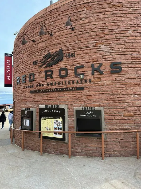 The round stone entrance wall marks Red Rocks Amphitheatre.