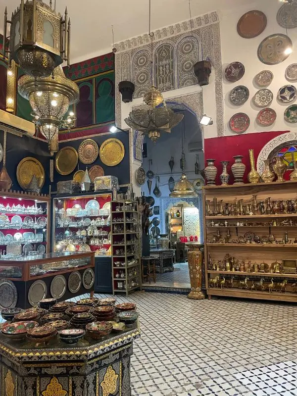 Traditional shop in Fez filled with brassware, ceramics, and lanterns.