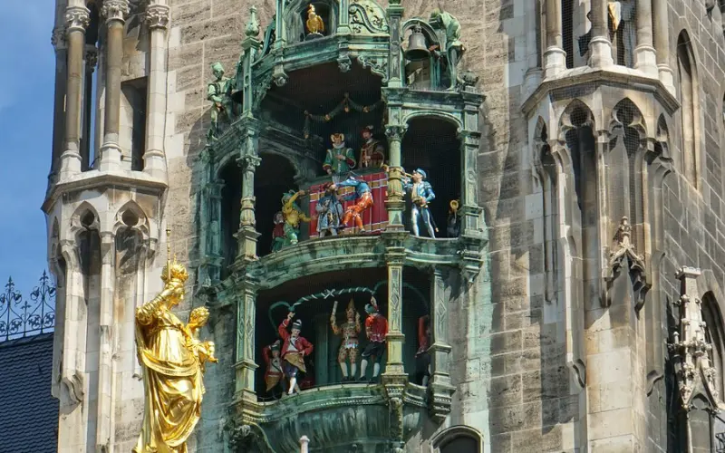 Close-up of the Glockenspiel in Munich with colorful figurines on a historic tower.