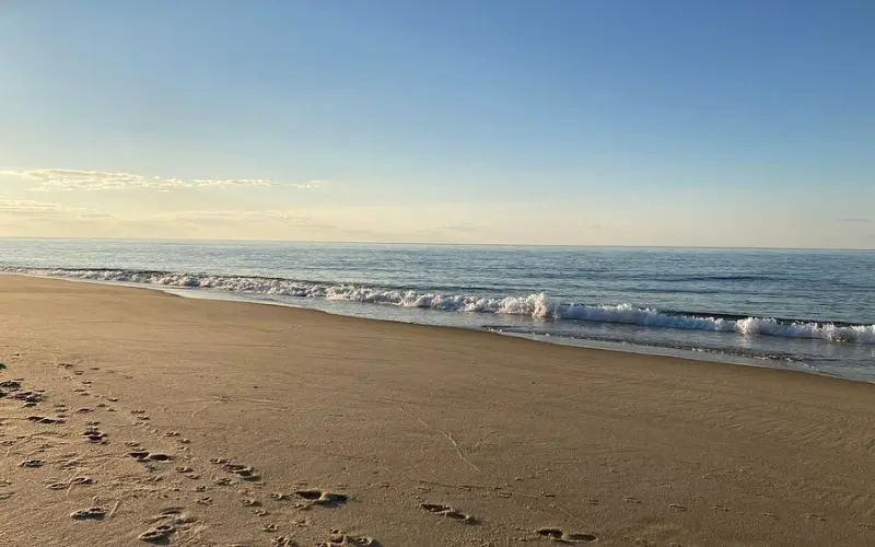 Gentle waves and footprints along the sandy shore at Race Point Beach.