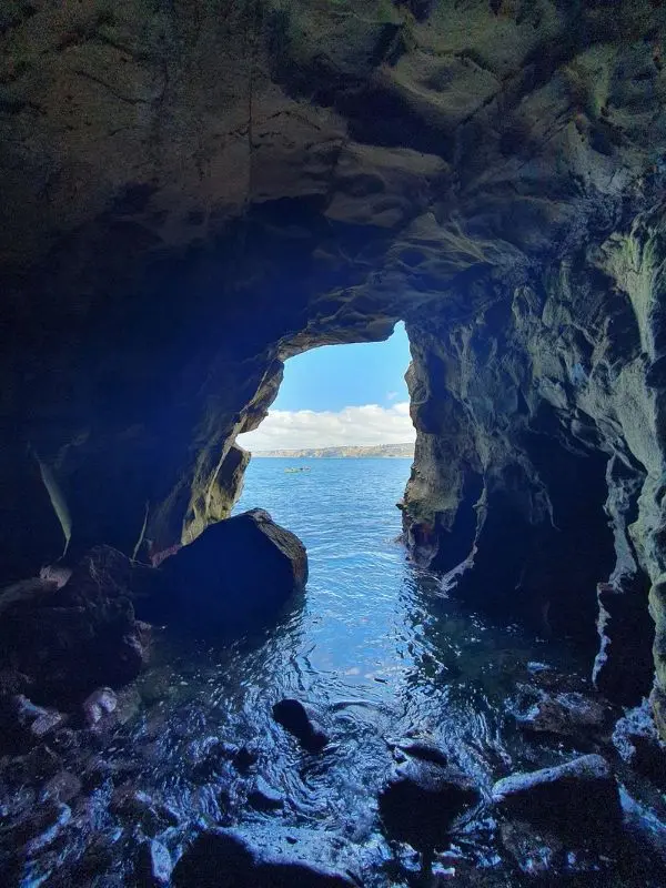 Ocean view framed by the entrance of Sunny Jim Cave.