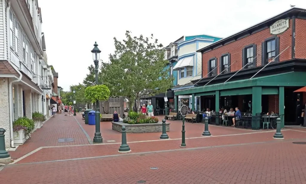 A charming pedestrian street at Washington Street Mall with shops, trees, and outdoor dining.