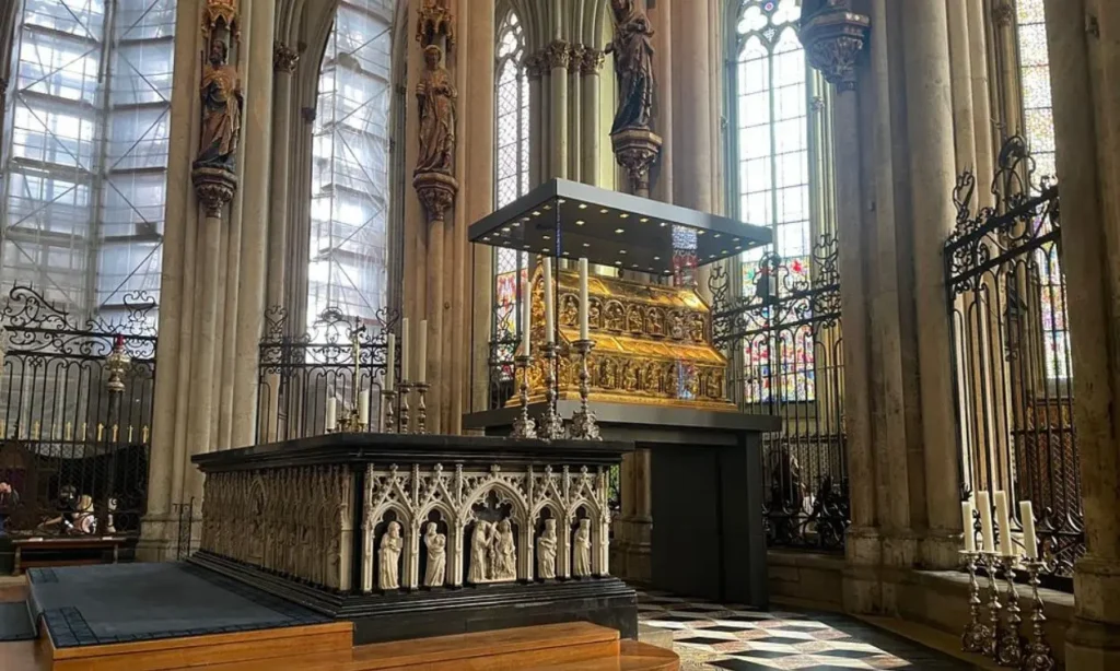 Interior of Cologne Cathedral showcasing the ornate golden shrine and Gothic architecture.
