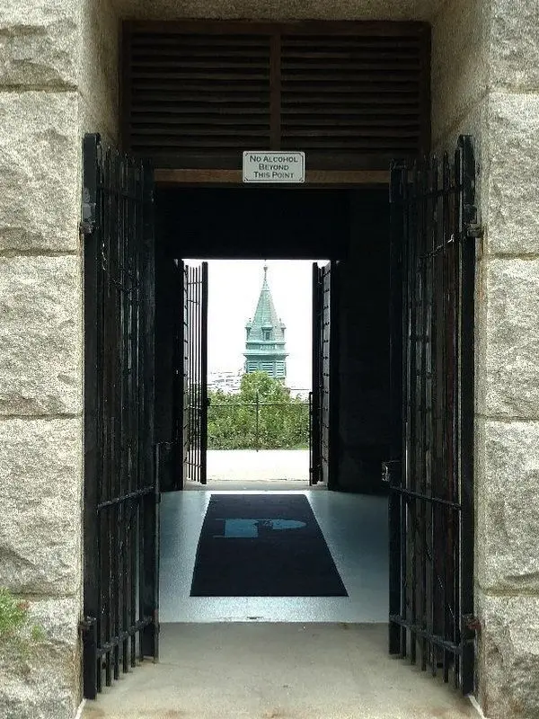 A steeple framed through the stone entrance of Provincetown Museum.