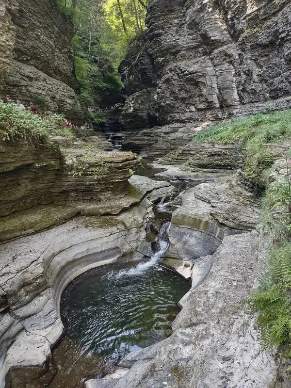 Water flows through layered rock formations at Watkins Glen State Park.