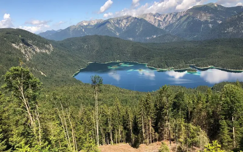 Aerial view of Eibsee Lake surrounded by mountains near Zugspitze.