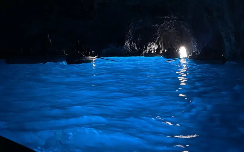 Blue glowing water inside the Blue Grotto of Capri.