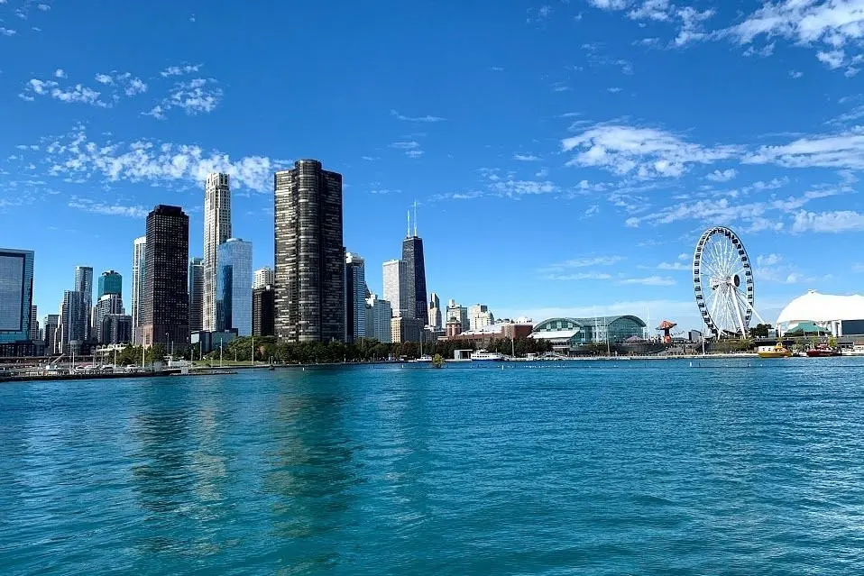 Chicago skyline and Ferris wheel along the shore of Lake Michigan.