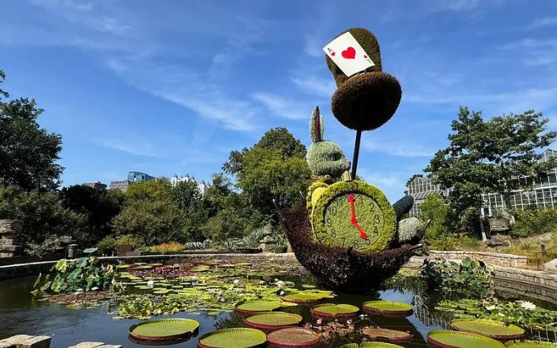 Topiary sculpture of the White Rabbit with giant lily pads at Atlanta Botanical Garden.