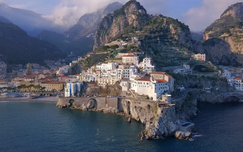 Coastal town of Sorrento with buildings on rocky cliffs.