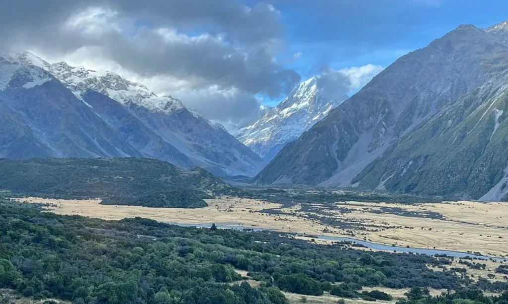 Snow-capped mountains and grassy plains in Aoraki / Mount Cook National Park.