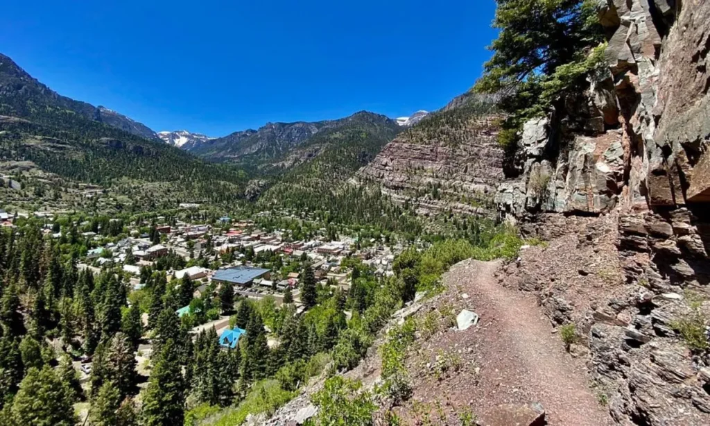 Ouray Perimeter Trail running along a rocky mountainside overlooking the town.