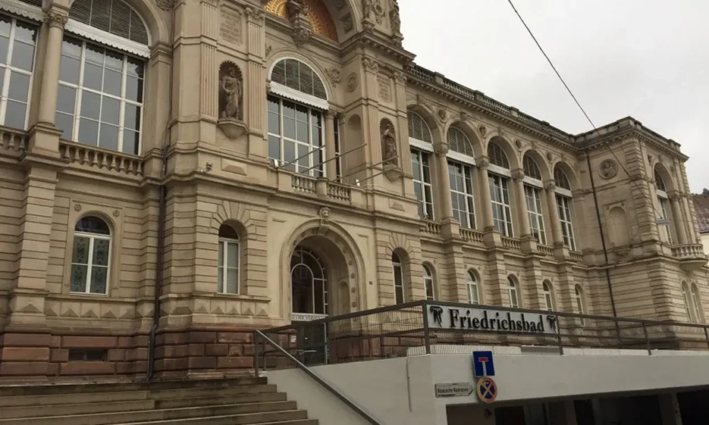 Exterior of Friedrichsbad building with arched windows and detailed stonework.