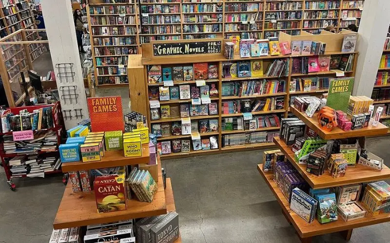 Shelves filled with books and games inside Powell’s City of Books.