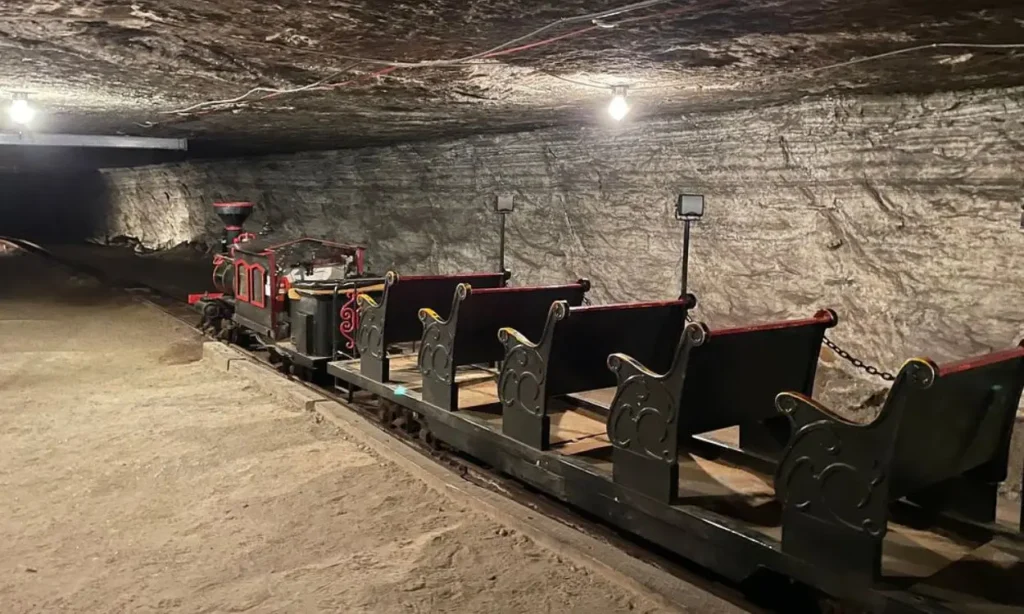 An underground train ride inside Strataca surrounded by salt mine walls.