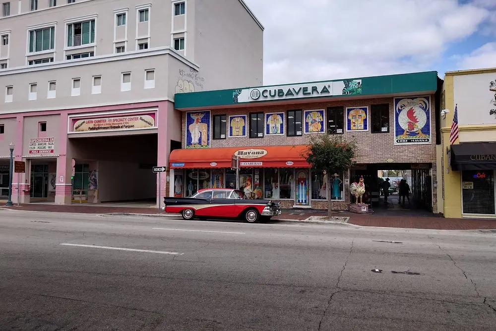 A colorful street with shops and a classic car in Little Havana, Miami.