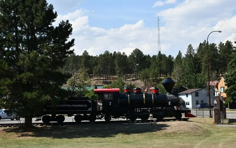 A vintage black locomotive on display at the 1880 Train.
