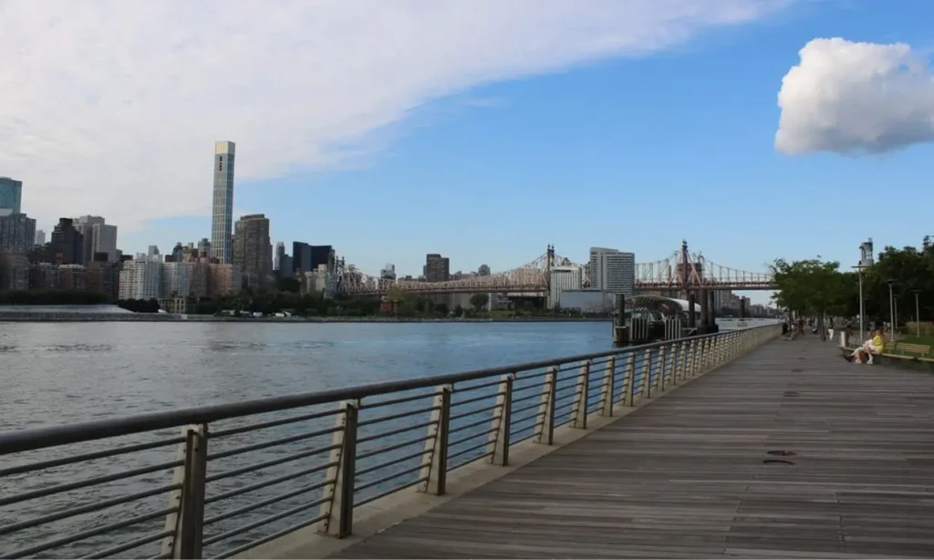 The boardwalk at Gantry Plaza State Park overlooks the river and city skyline.