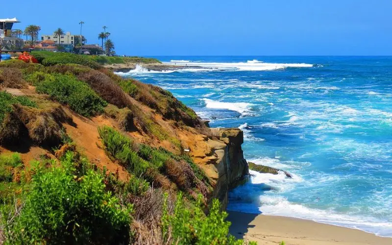 Waves crash against rocky cliffs at La Jolla Cove.