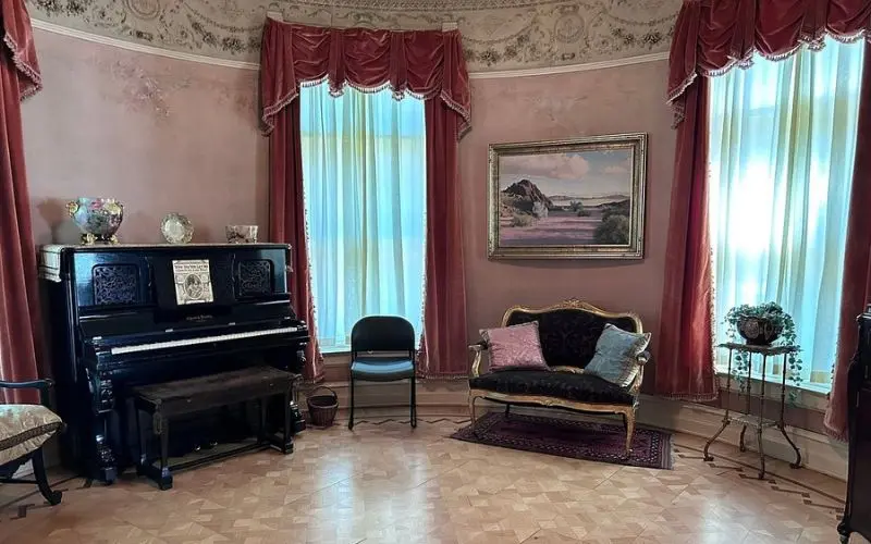 An elegant parlor with antique furniture inside the Historic Adams House.