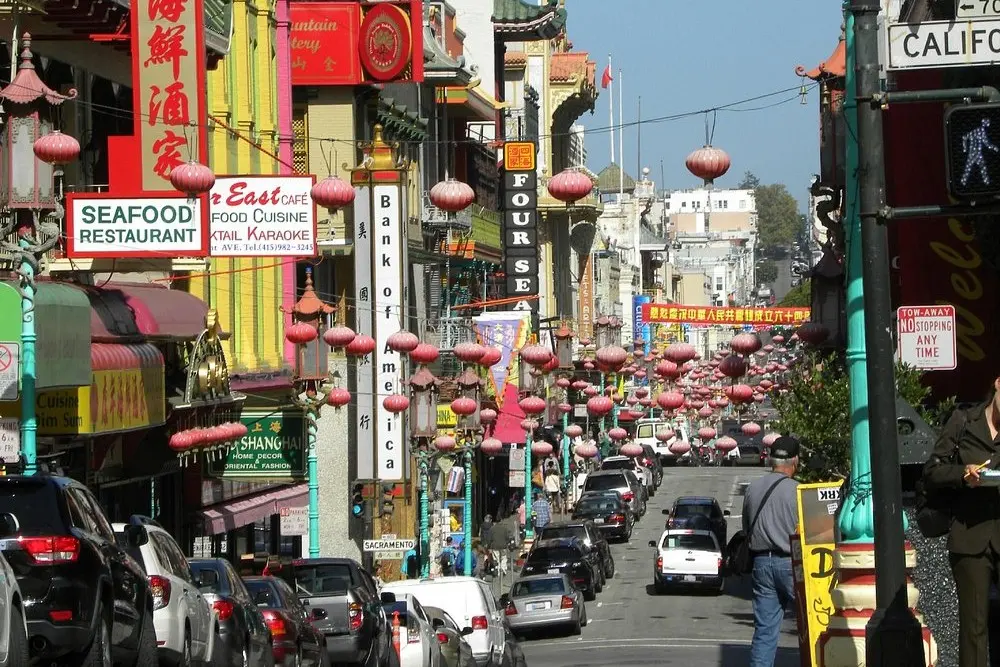 A busy street lined with lanterns and shops in Chinatown, San Francisco.