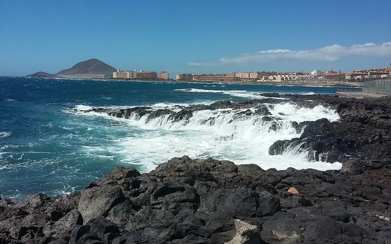 Waves crashing on volcanic rocks at El Médano in Tenerife.