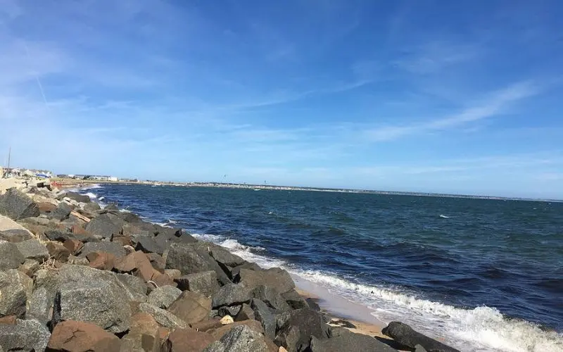 Rocky shoreline and blue water at Provincetown Harbor.