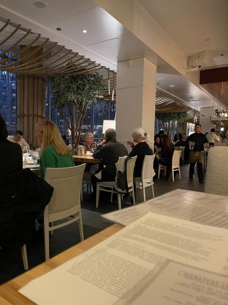Avli on The Park dining room with guests seated at modern tables under soft lighting.