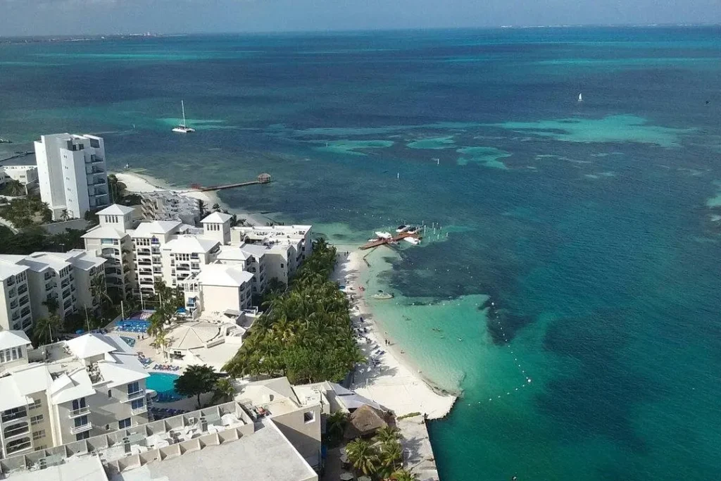 White beachfront resorts line the turquoise waters of Cancun, Mexico.