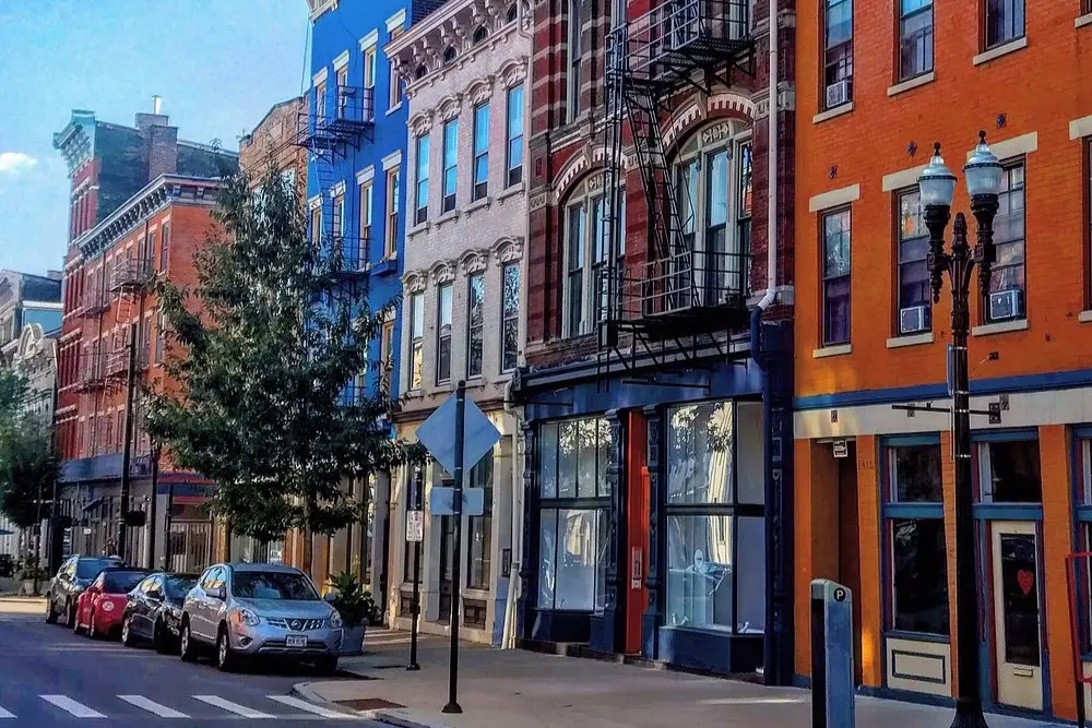 Colorful historic buildings line a quiet street in the Over-the-Rhine neighborhood of Cincinnati.