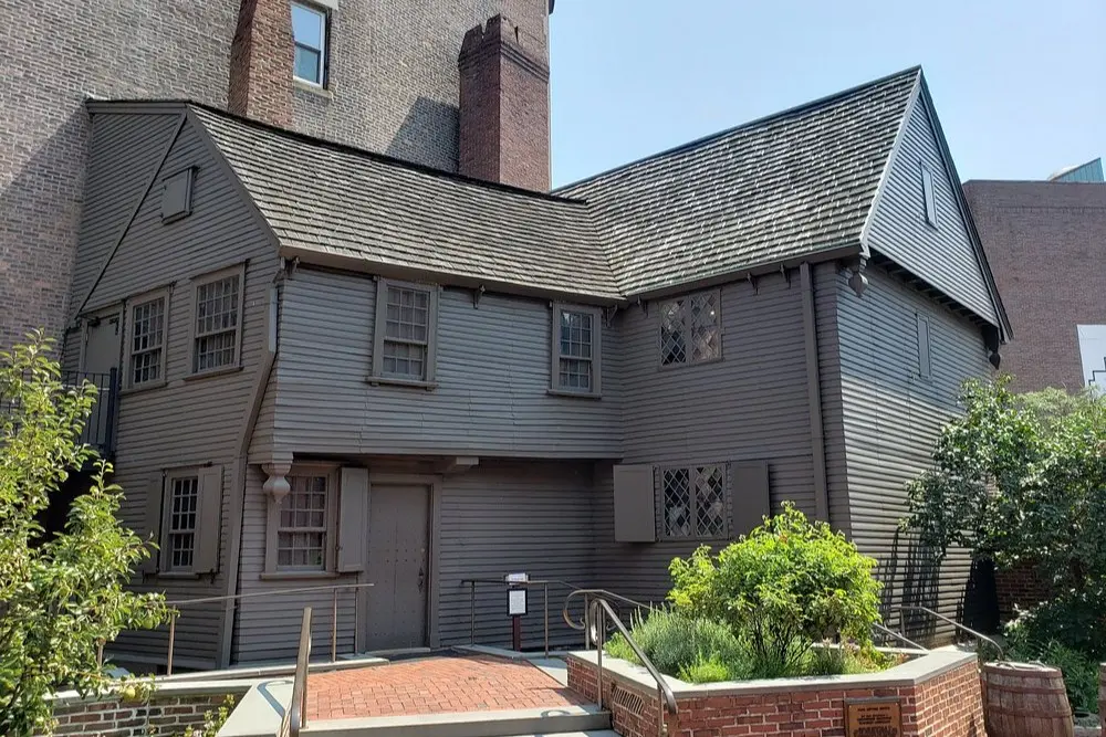 The Paul Revere House in Boston, a historic wooden building with dark siding and small windows.