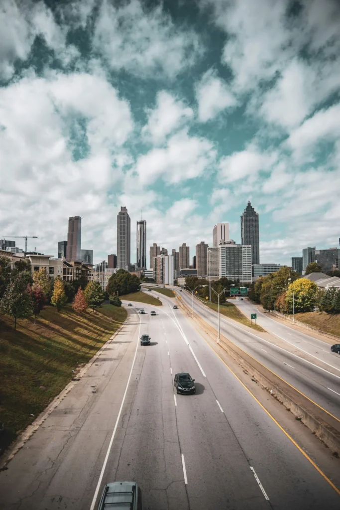 Downtown Atlanta city skyline viewed from above a multi-lane highway corridor