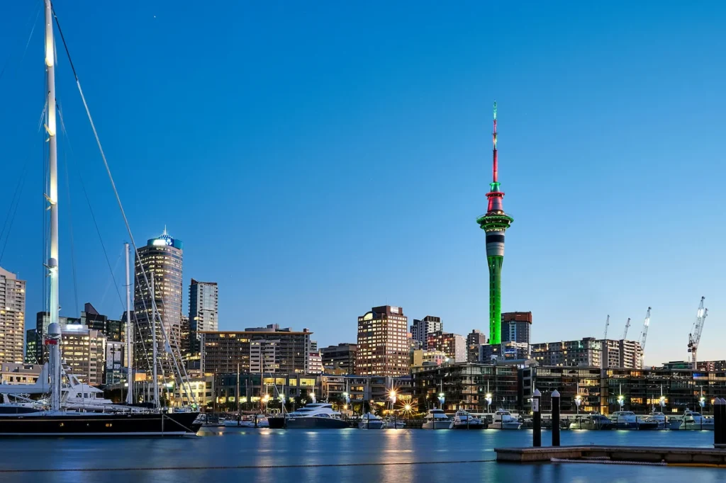 Auckland skyline and illuminated Sky Tower viewed from a marina