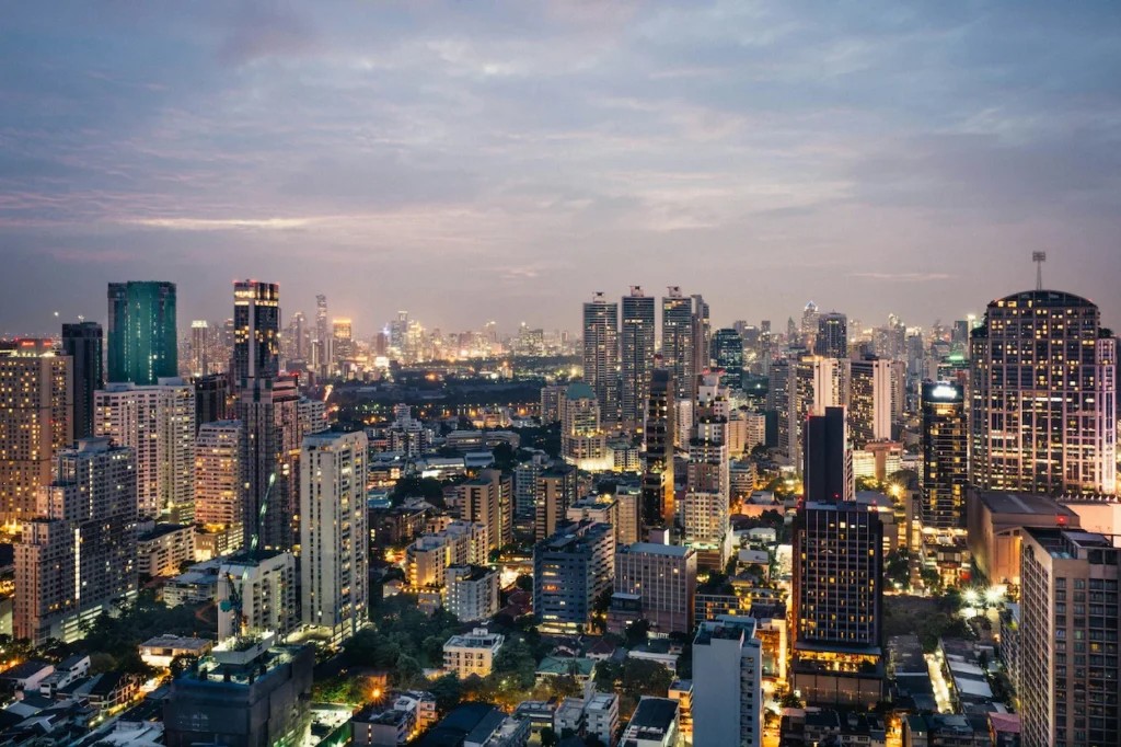 High-angle panoramic view of the illuminated Bangkok city skyline at dusk