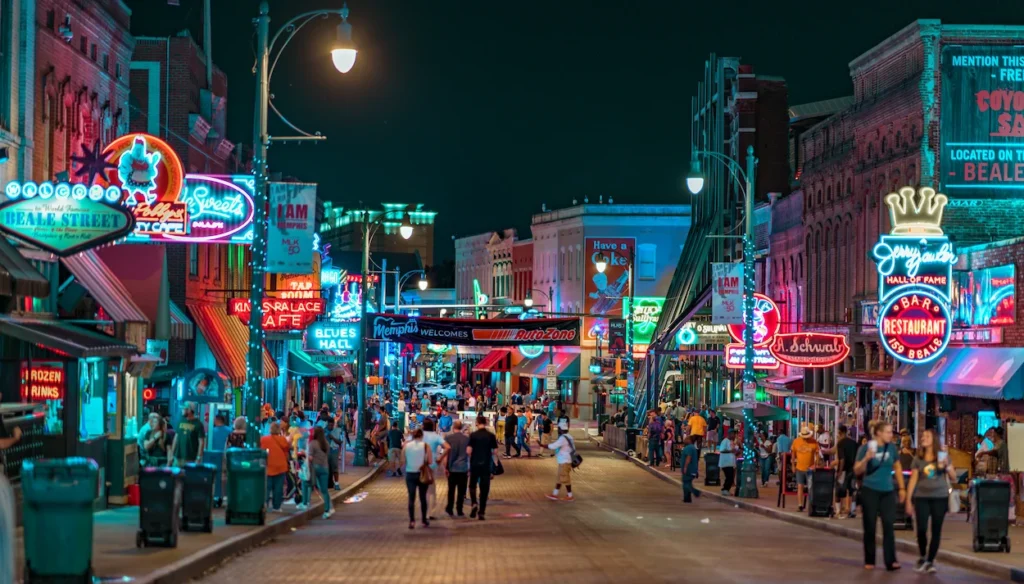 Bright neon signs lighting up the crowded Beale Street entertainment district in Memphis at night