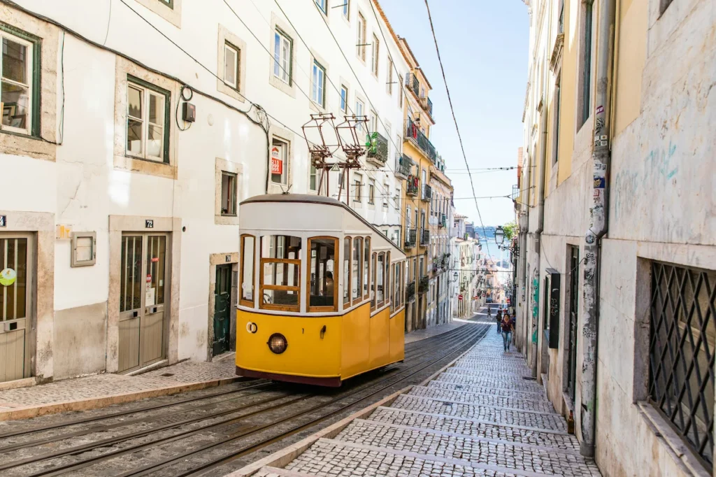 Bica Funicular tram on a steep track lined with historic buildings in Lisbon